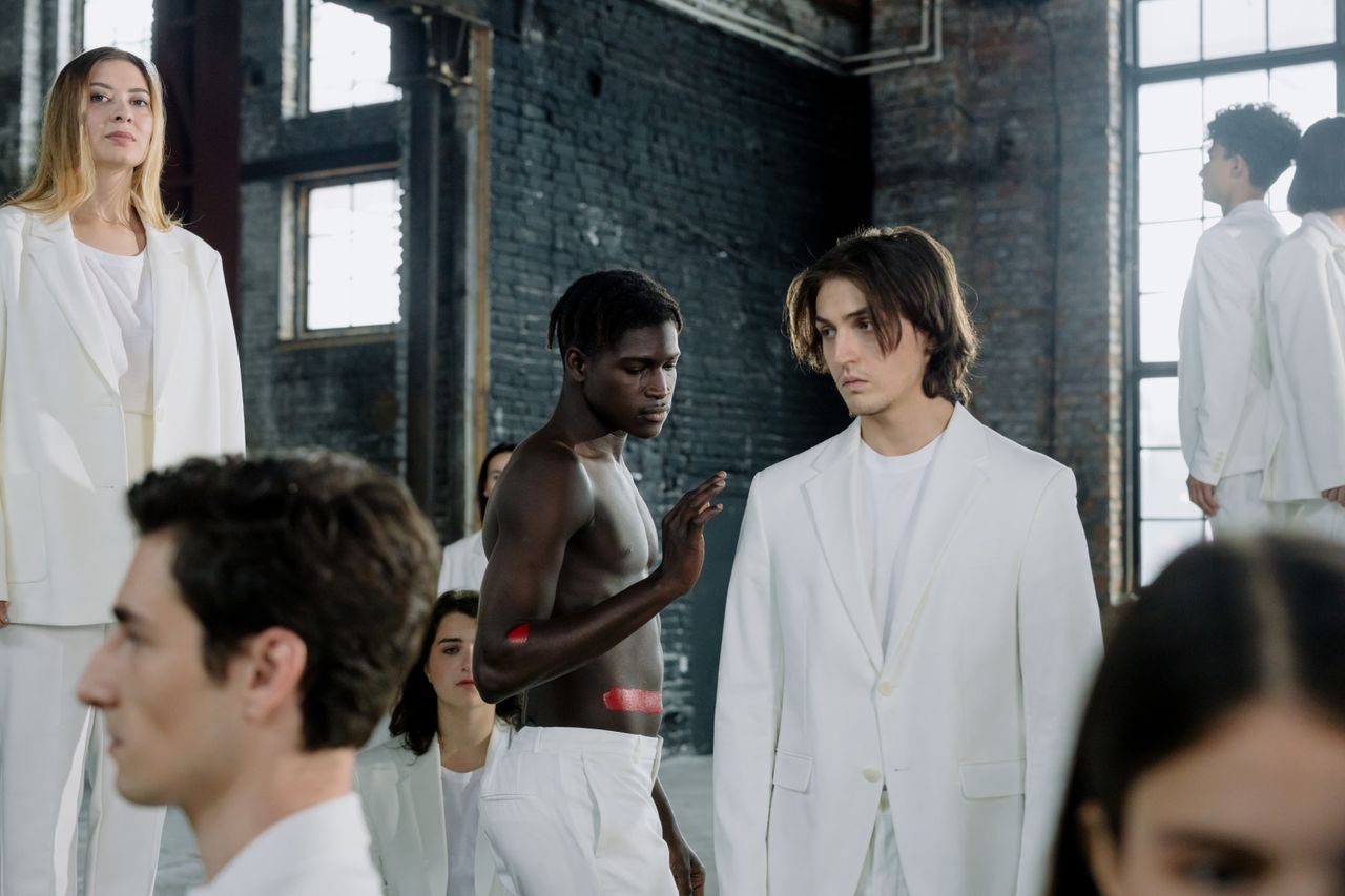 hero-img-01 Models in a fashion shoot wearing white outfits in an industrial space.