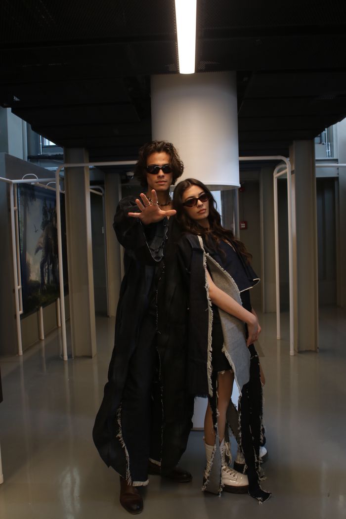 gallery-3 Trendy man and woman with sunglasses posing in a modern art gallery. Fashionable and edgy.