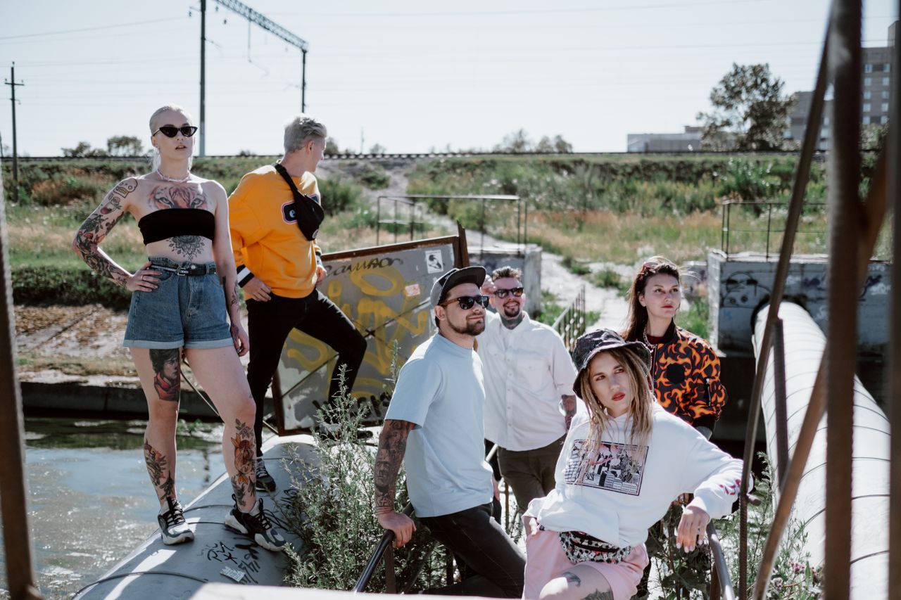 services-01 Fashionable group posing in streetwear by an industrial outdoor area.